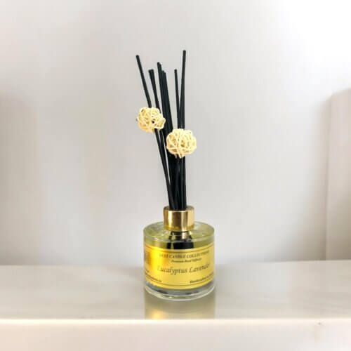 Eucalyptus Lavender Reed Diffuser Bottle with reeds on wooden counter