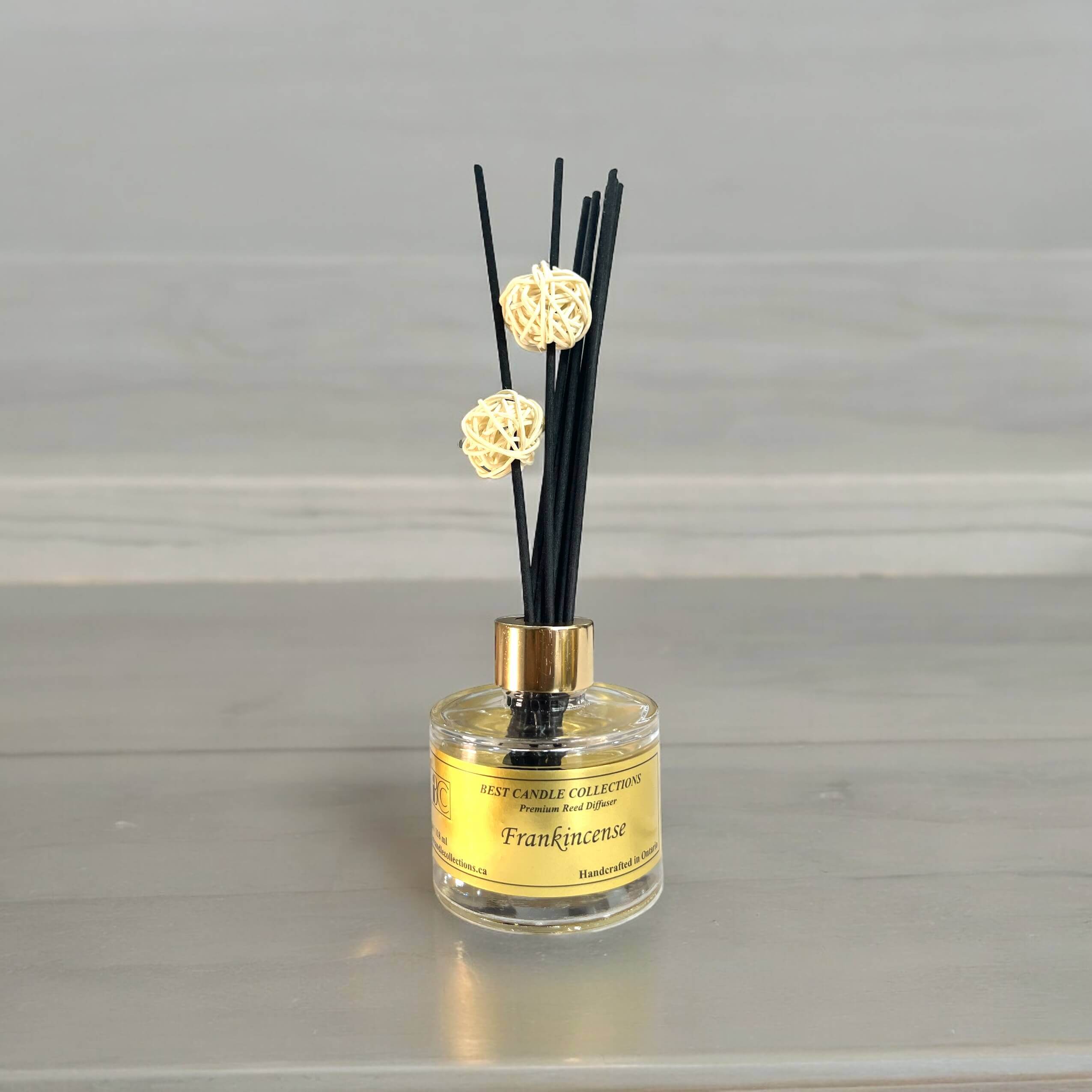 Frankincense Reed Diffuser Bottle with reeds in the bottle on a table