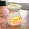 White Ceramic Tea Light Wax Melter with lit tea light and wax melts